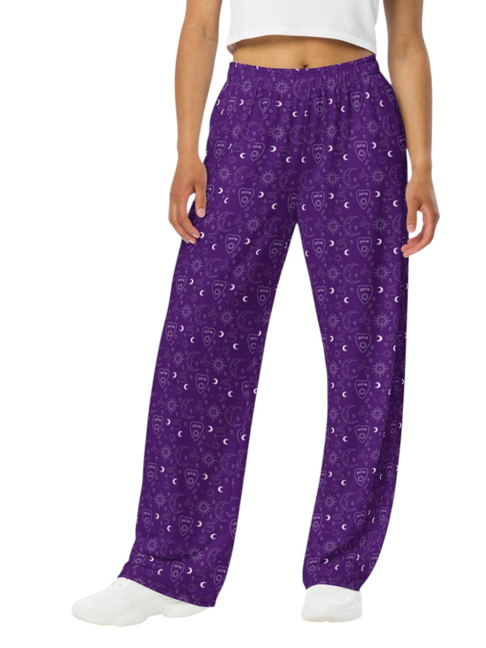 Woman wearing purple Whimsigoth wide leg lounge pants with celestial moon and sun print.