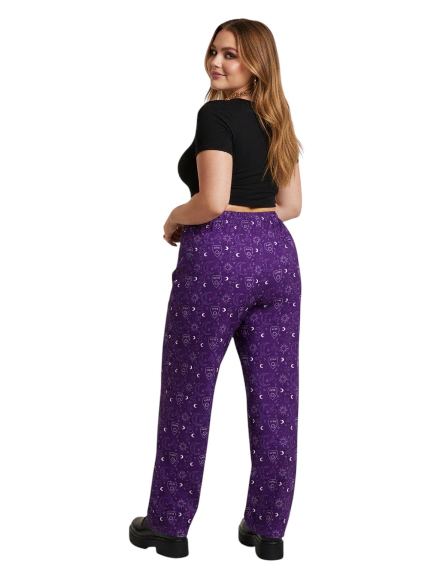 Woman wearing purple Whimsigoth wide leg lounge pants with celestial moon and sun print.