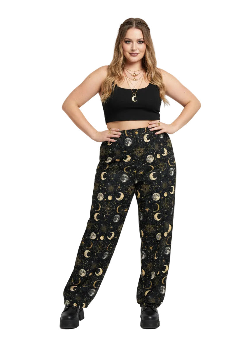 Woman wearing Whimsigoth celestial wide leg lounge pants with sun, moon, and star print.