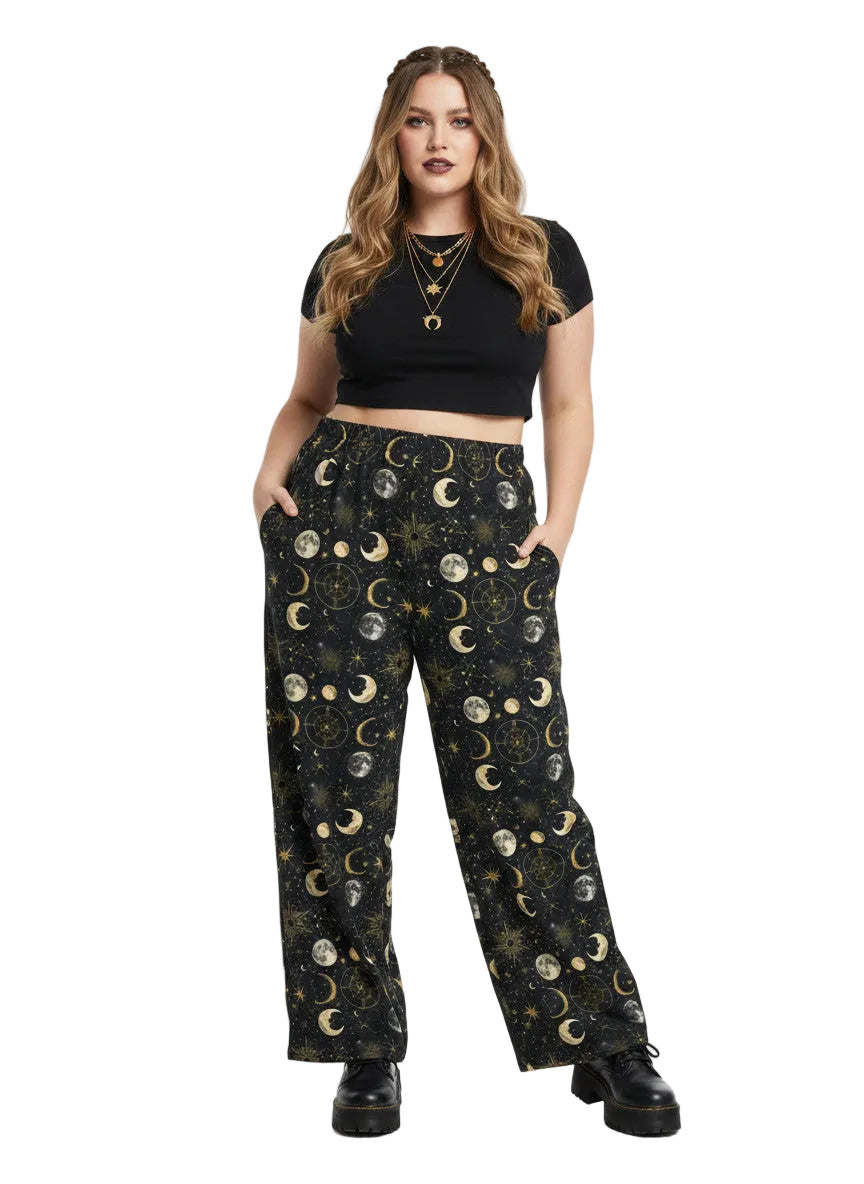 Woman wearing Whimsigoth celestial wide leg lounge pants with sun, moon, and star print.