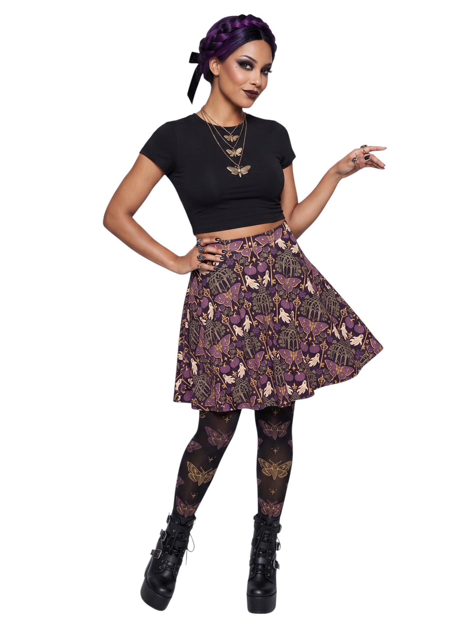 Woman wearing a purple Whimsigoth moth print goth flare skirt with black crop top and moth tights.