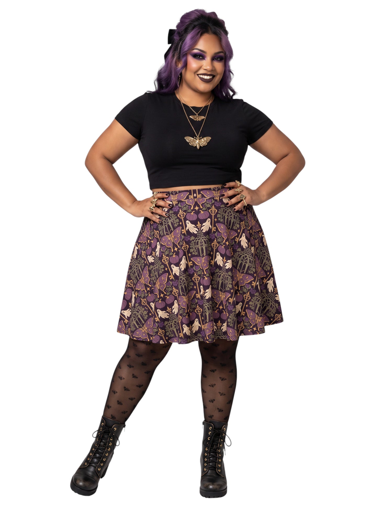 Woman wearing a purple Whimsigoth moth print goth flare skirt with black crop top and moth tights.