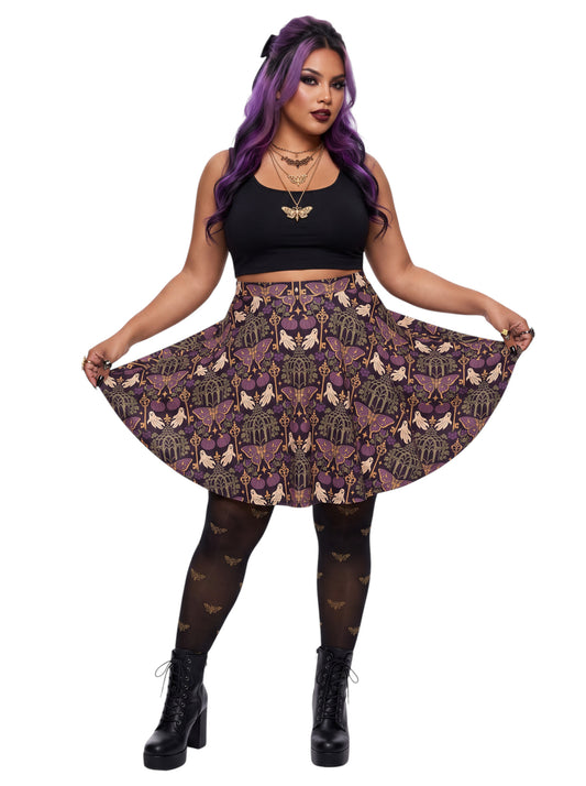 Woman wearing a purple Whimsigoth moth print goth flare skirt with black crop top and moth tights.