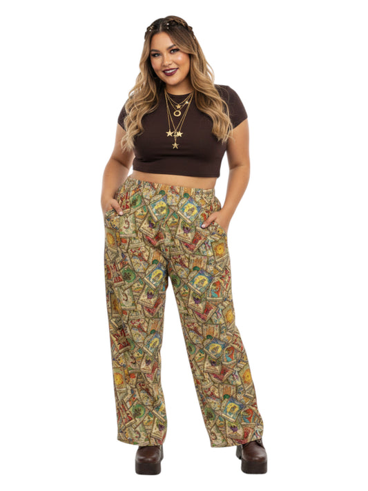 Woman wearing Whimsigoth wide leg lounge pants with vintage tarot card print and practical side pockets.