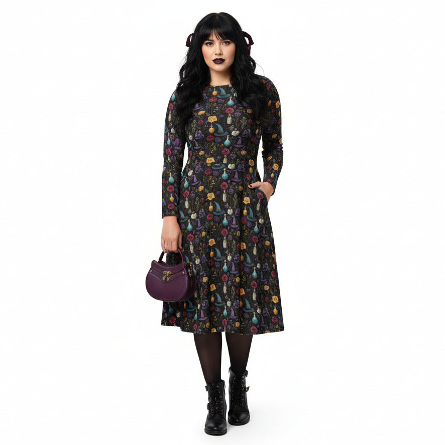 Woman wearing a patterned dress with a purple handbag on a white background