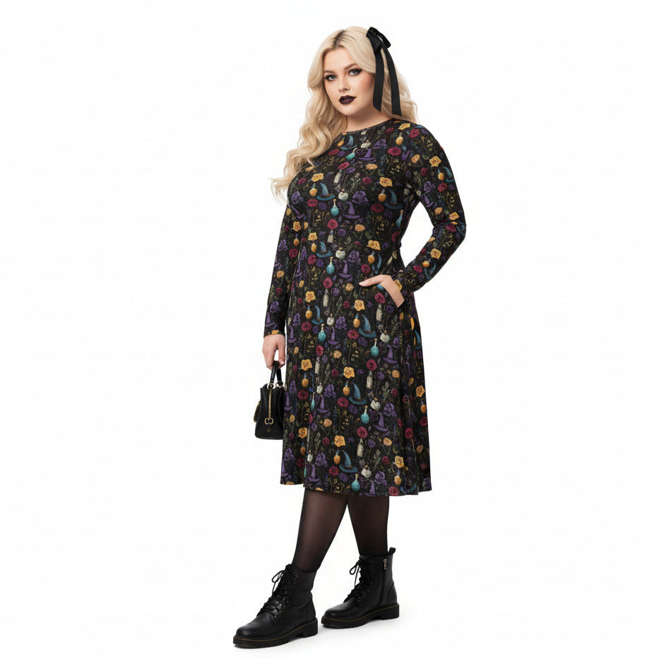 Woman wearing a black dress with colorful patterns on a white background