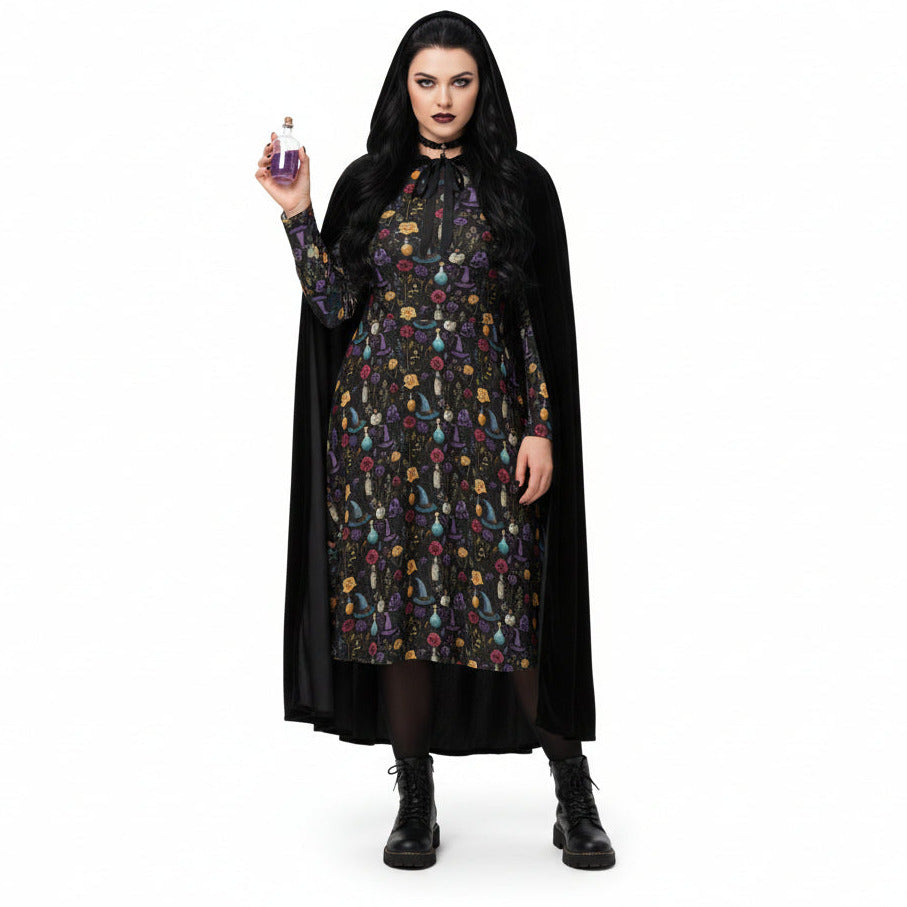 Woman in a black cape and patterned dress holding a purple object on a white background