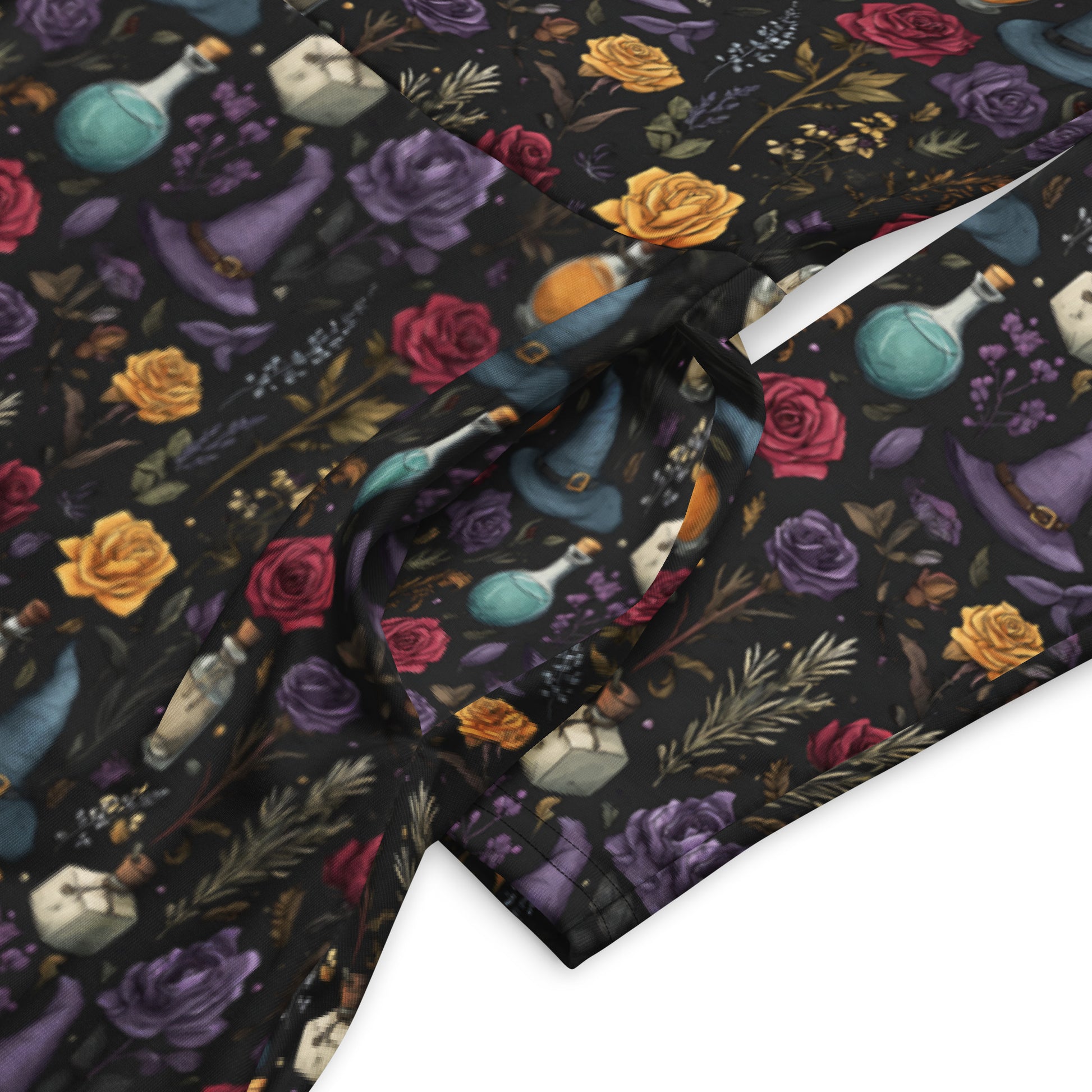 Fabric with colorful floral and potion design on a dark background