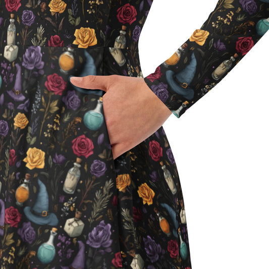 Close-up of a dark fabric with colorful witch hat, potion bottle, and rose pattern.