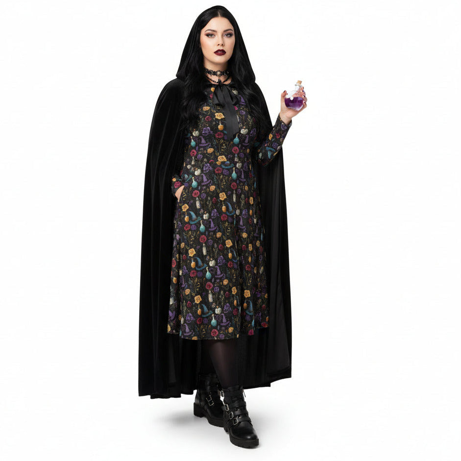 Person wearing a black cape and floral dress holding a purple potion on a white background