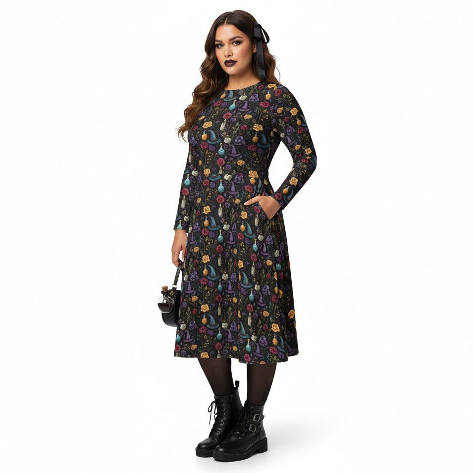 Woman wearing a black dress with colorful floral pattern on a white background