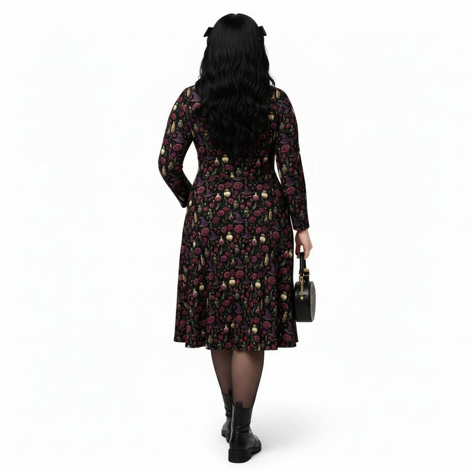 Woman wearing a floral dress holding a handbag on a white background