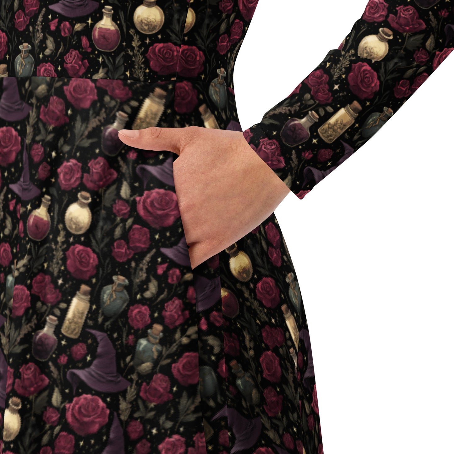 Long-sleeve shirt with a dark floral and potion bottle pattern on a white background