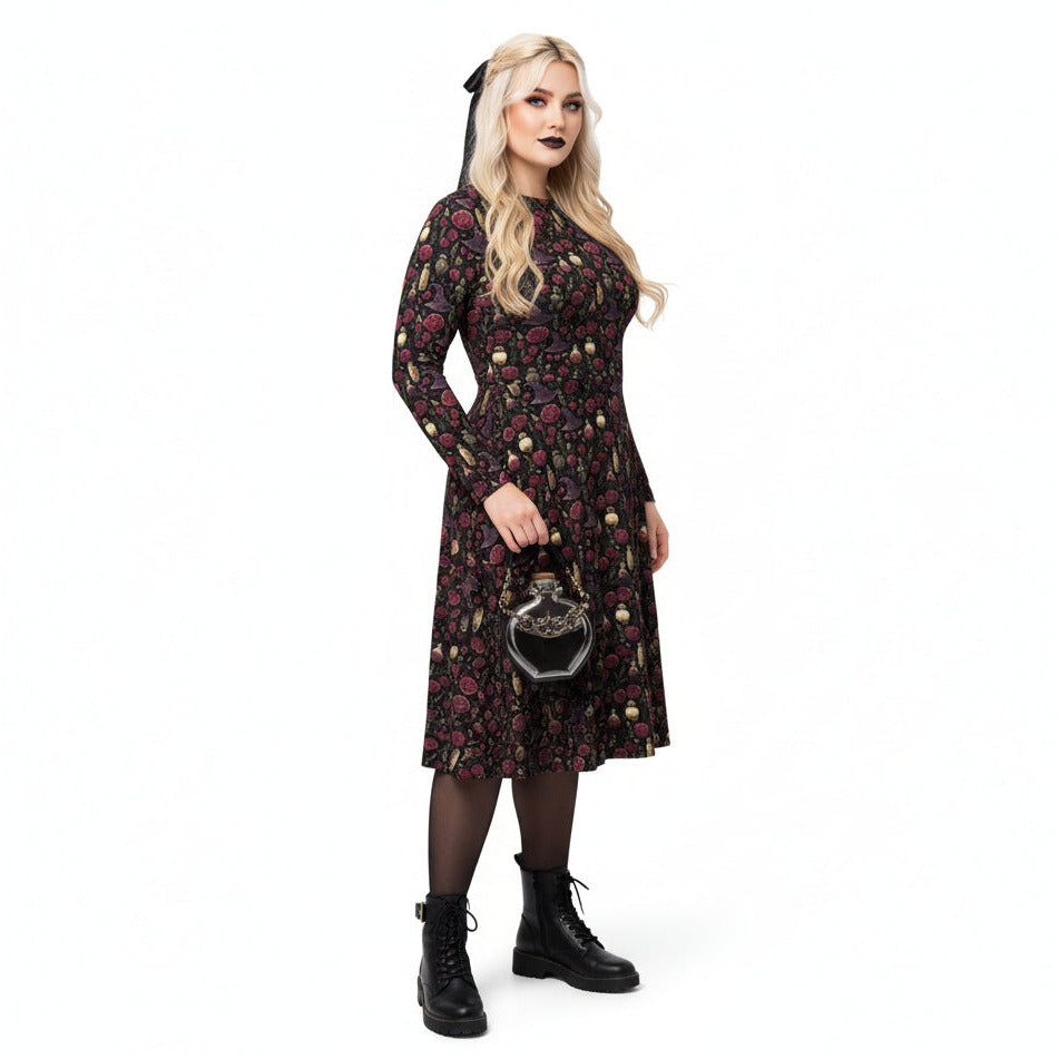 Woman wearing a dark floral dress with long sleeves on a white background