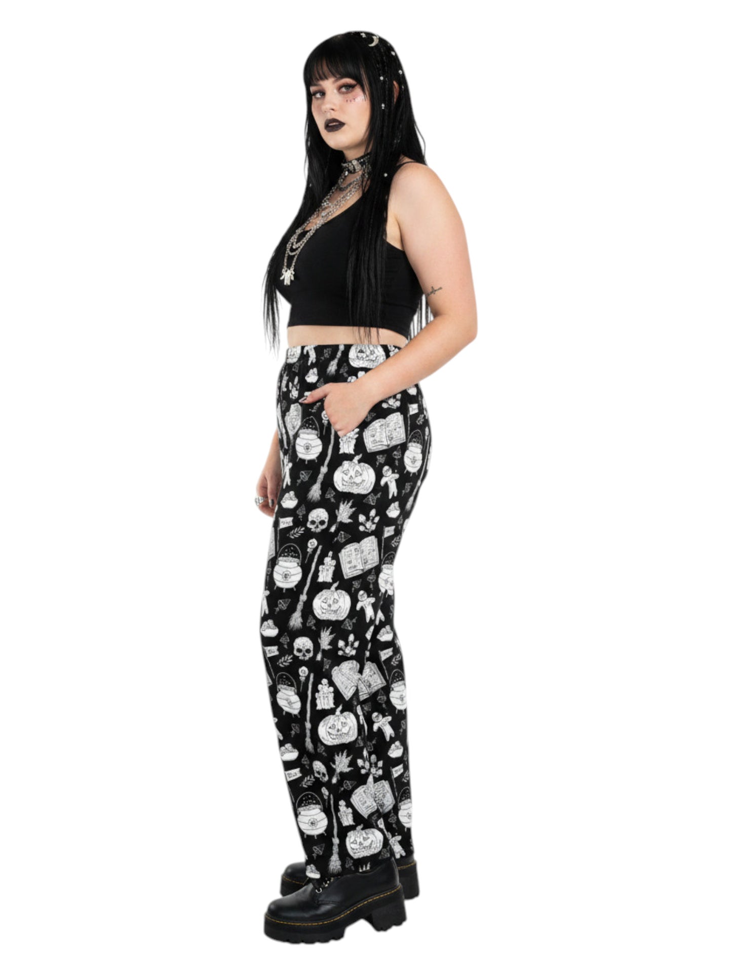 Woman wearing black and white witchy voodoo doll print wide leg lounge pants with side pockets.