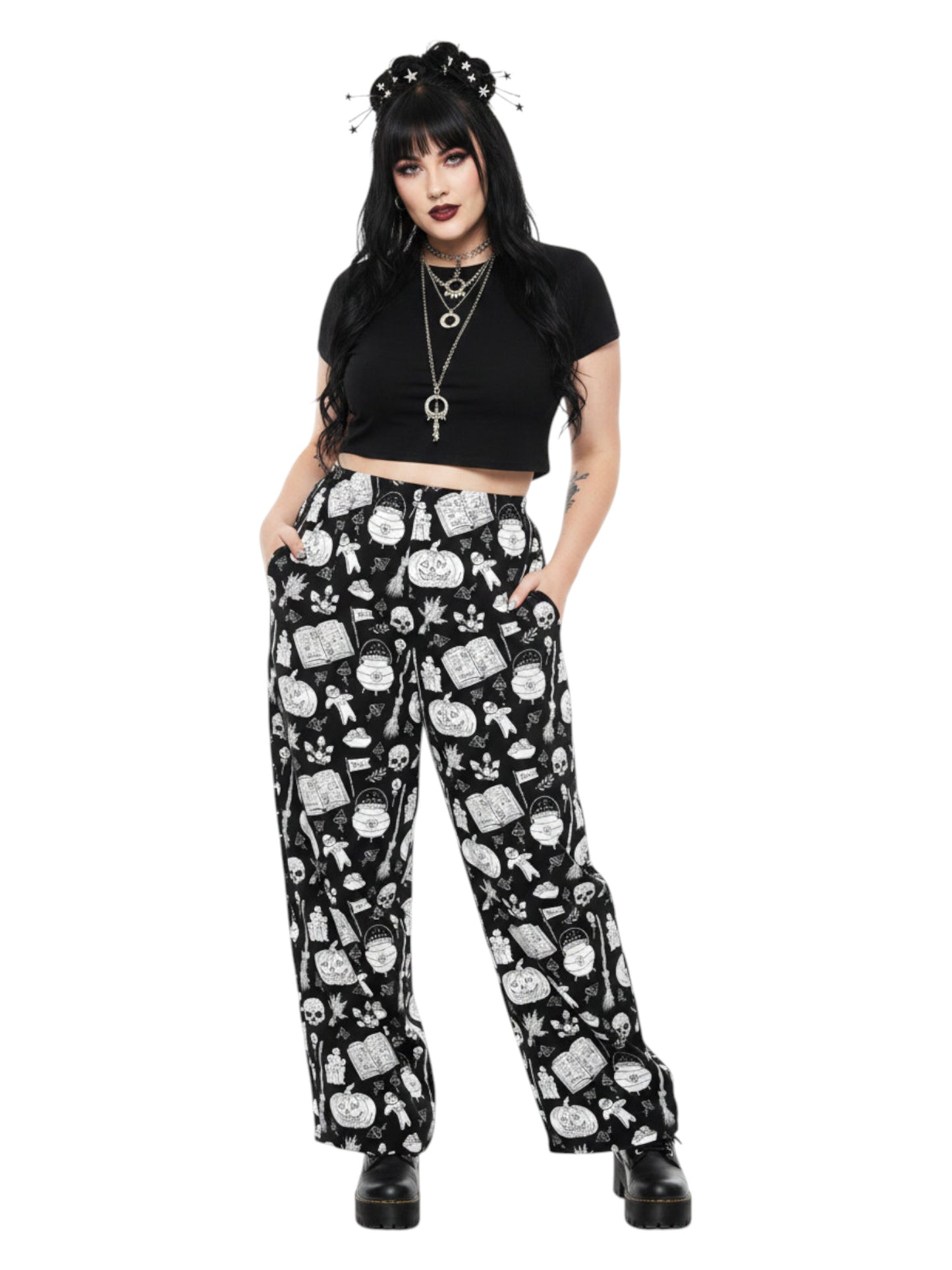 Woman wearing black and white witchy voodoo doll print wide leg lounge pants with side pockets.