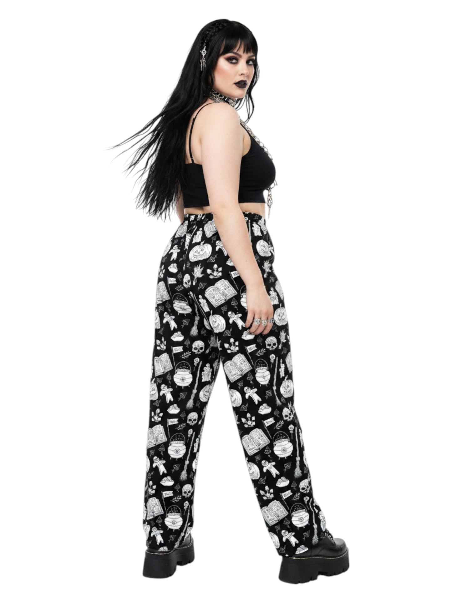Woman wearing black and white witchy voodoo doll print wide leg lounge pants with side pockets.