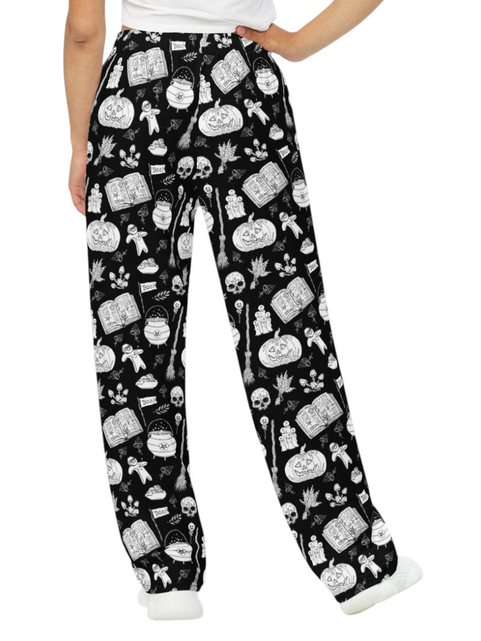 Woman wearing black and white witchy voodoo doll print wide leg lounge pants with side pockets.