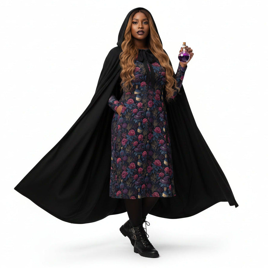 Person wearing a black cape over a floral dress, holding a scepter on a white background