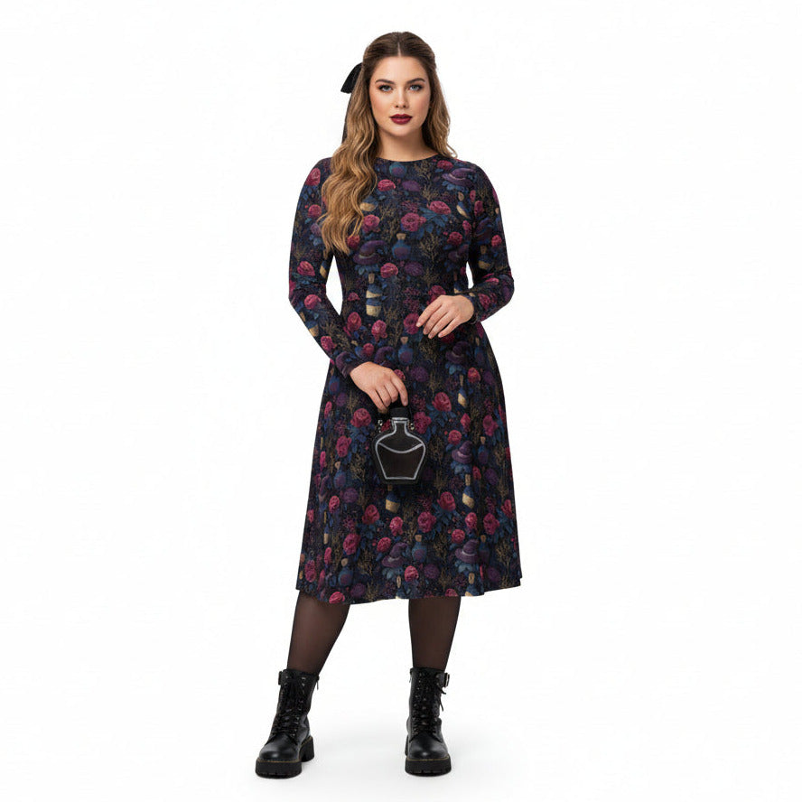 Woman wearing a floral dress holding a small bag on a white background