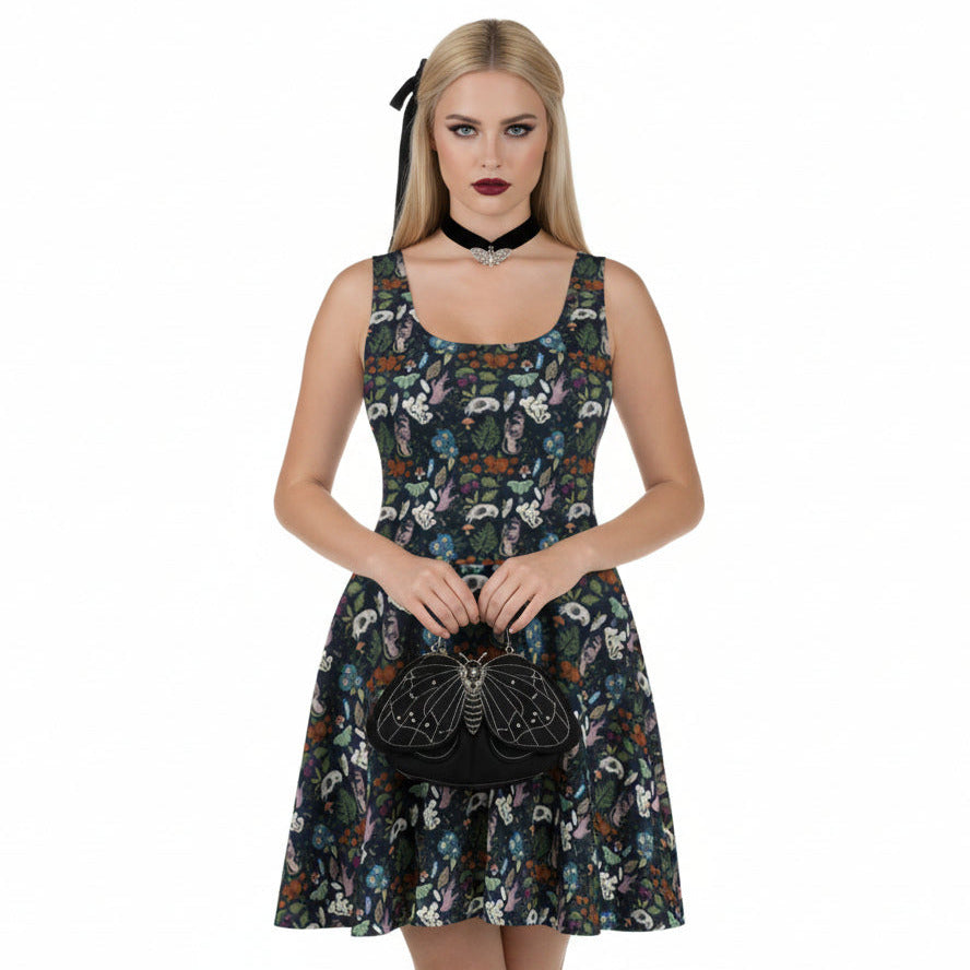 Woman wearing a floral dress holding a black handbag on a white background